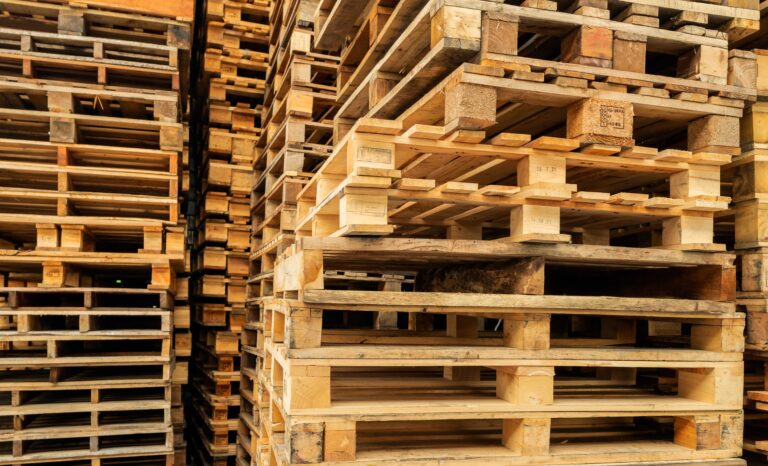Stack of wooden pallet. Industrial wood pallet at factory warehouse. Cargo and shipping concept. Sustainability of supply chains. Eco-friendly nature and sustainable properties. Renewable wood pallet.